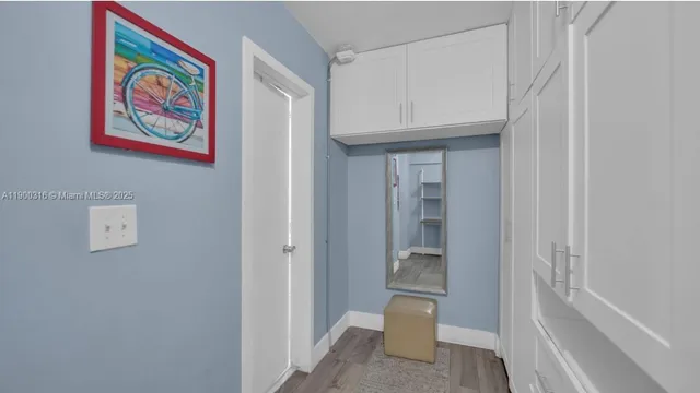 a view of an entryway with wooden floor