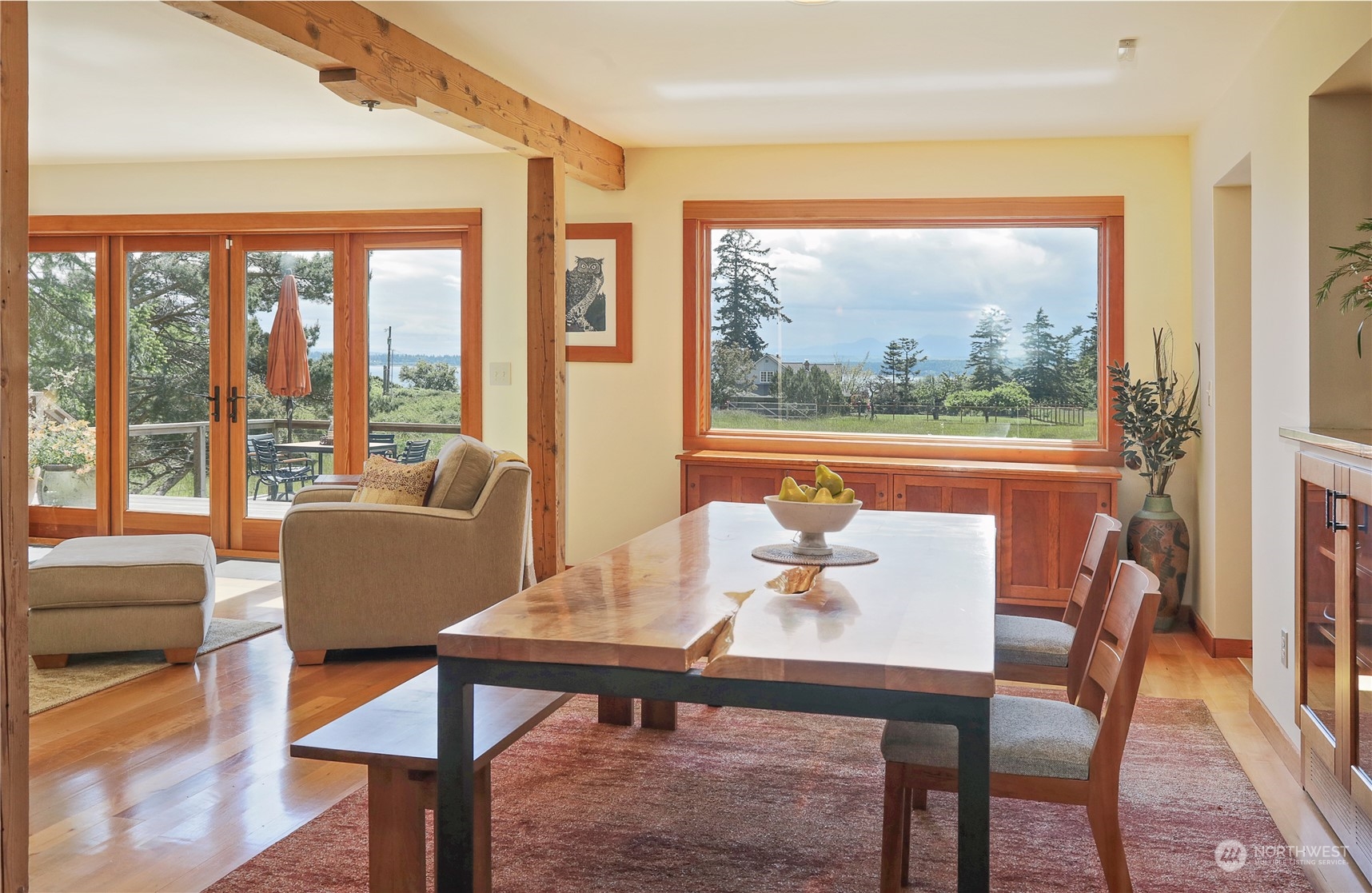 6567 Wahl Road Freeland, WA 98249 - Photo 11 of 40 a dining room with furniture a rug and a large window