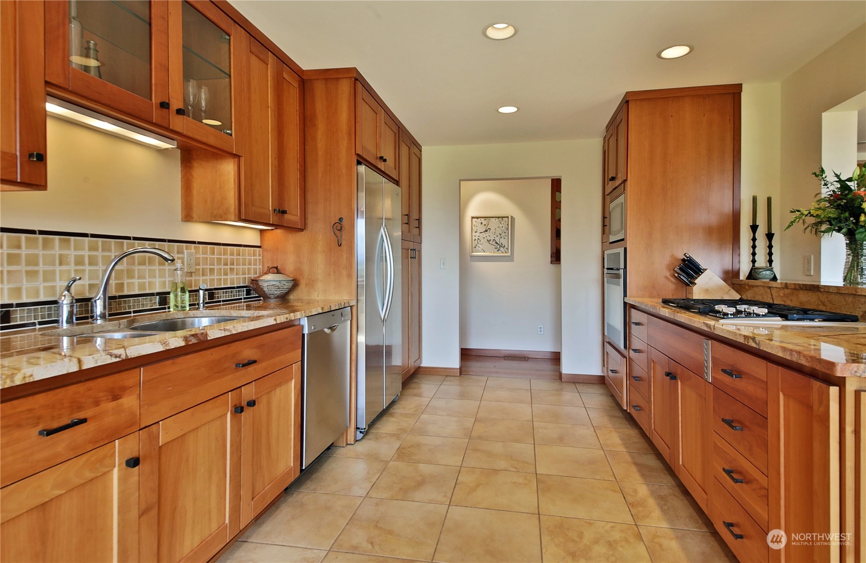6567 Wahl Road Freeland, WA 98249 - Photo 15 of 40 a large kitchen with stainless steel appliances granite countertop a sink and cabinets