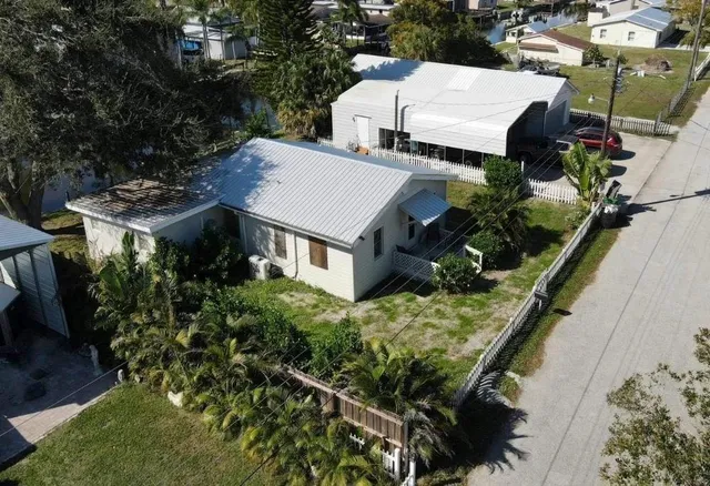 an aerial view of a house with a yard
