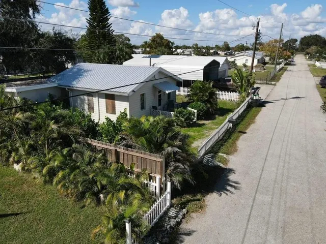 a view of a house with yard and sitting area