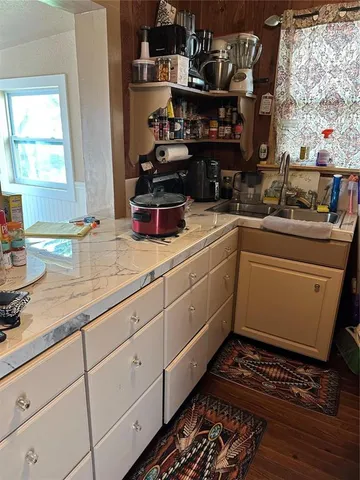 a kitchen with sink and cabinets