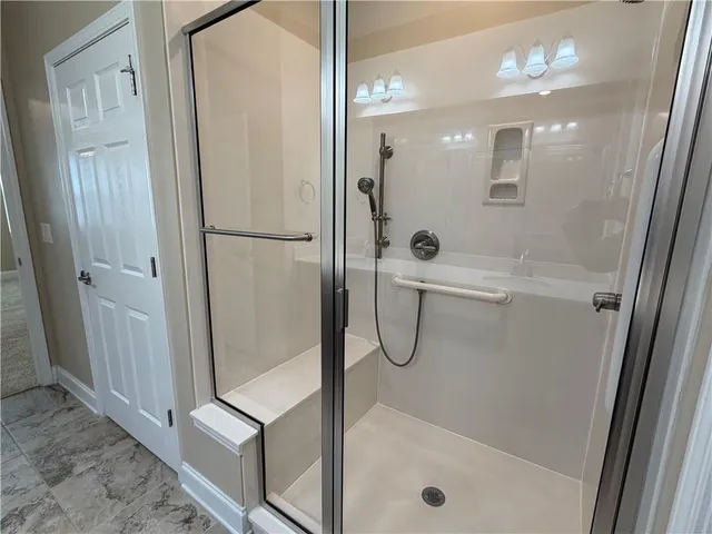 a bathroom with a shower and a mirror