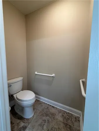 a white toilet sitting next to a shower