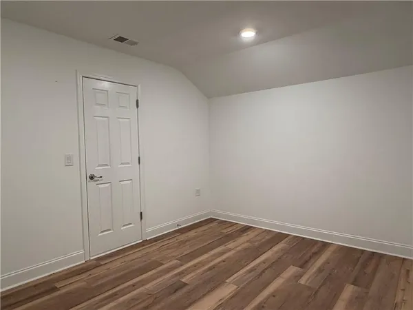 a view of room with wooden floor