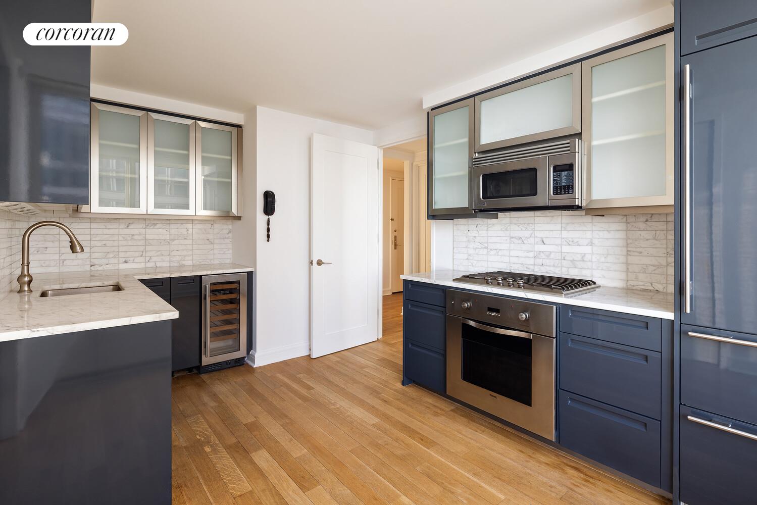 80 Riverside Boulevard, Unit 36B Manhattan, NY 10069 - Photo 7 of 25 a kitchen with stainless steel appliances granite countertop a stove top oven and sink