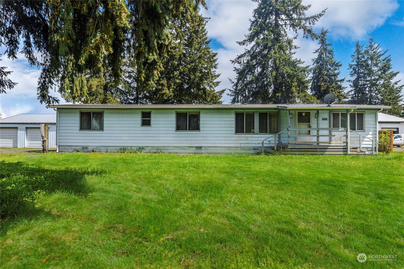 a front view of house with yard and green space