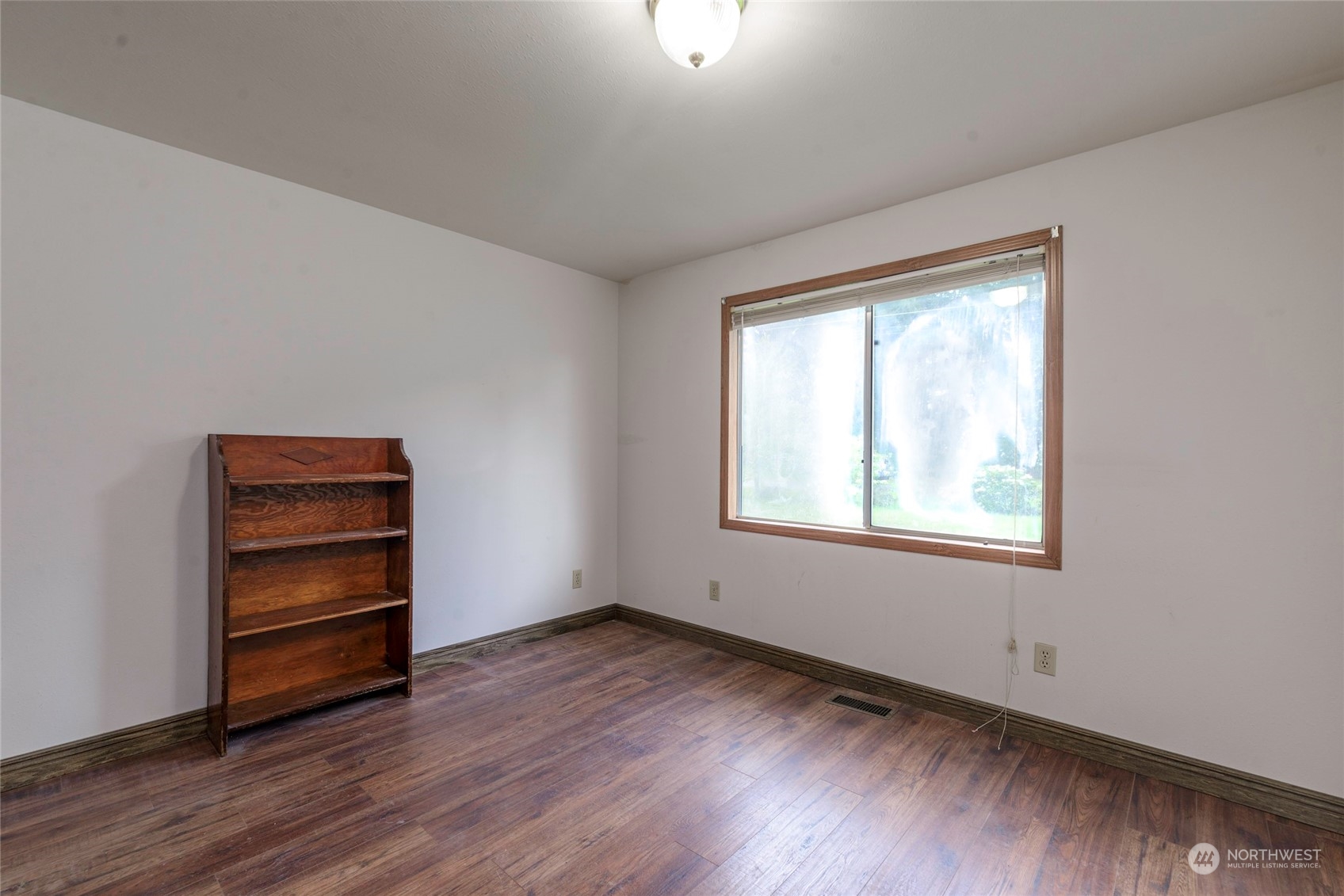 18524 Ivan Street Southwest Rochester, WA 98579 - Photo 12 of 20 wooden floor in an empty room with a window