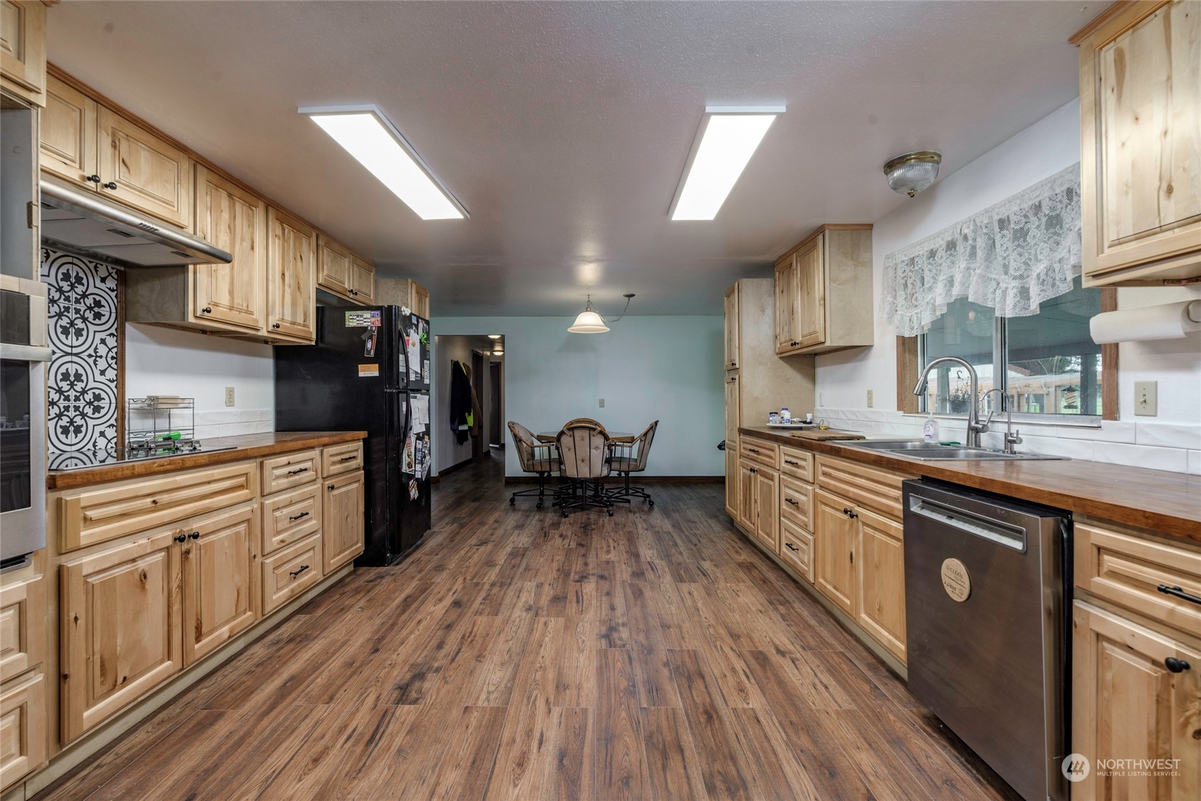 18524 Ivan Street Southwest Rochester, WA 98579 - Photo 8 of 20 a kitchen with granite countertop lots of counter top space and wooden floor