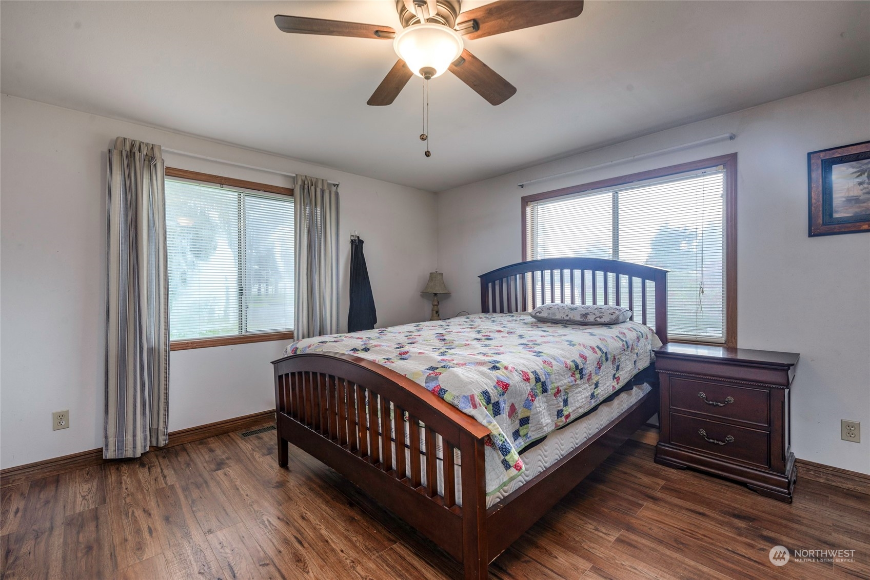 18524 Ivan Street Southwest Rochester, WA 98579 - Photo 9 of 20 a bedroom with a bed and a chandelier