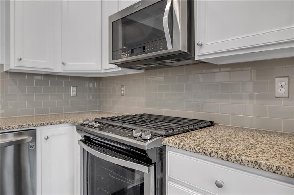 6513 Bennington Bluff Court, Unit 2 Mableton, GA 30126 - Photo 13 of 41 a kitchen with granite countertop a stove and a microwave
