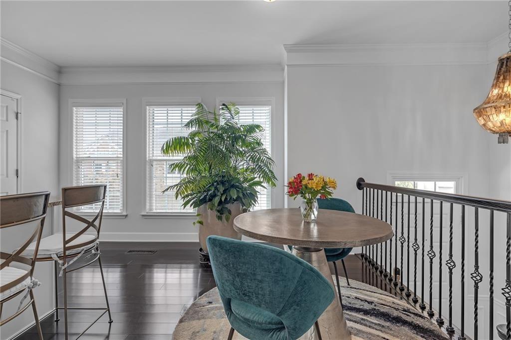 6513 Bennington Bluff Court, Unit 2 Mableton, GA 30126 - Photo 15 of 41 a dining room with furniture potted plants and wooden floor