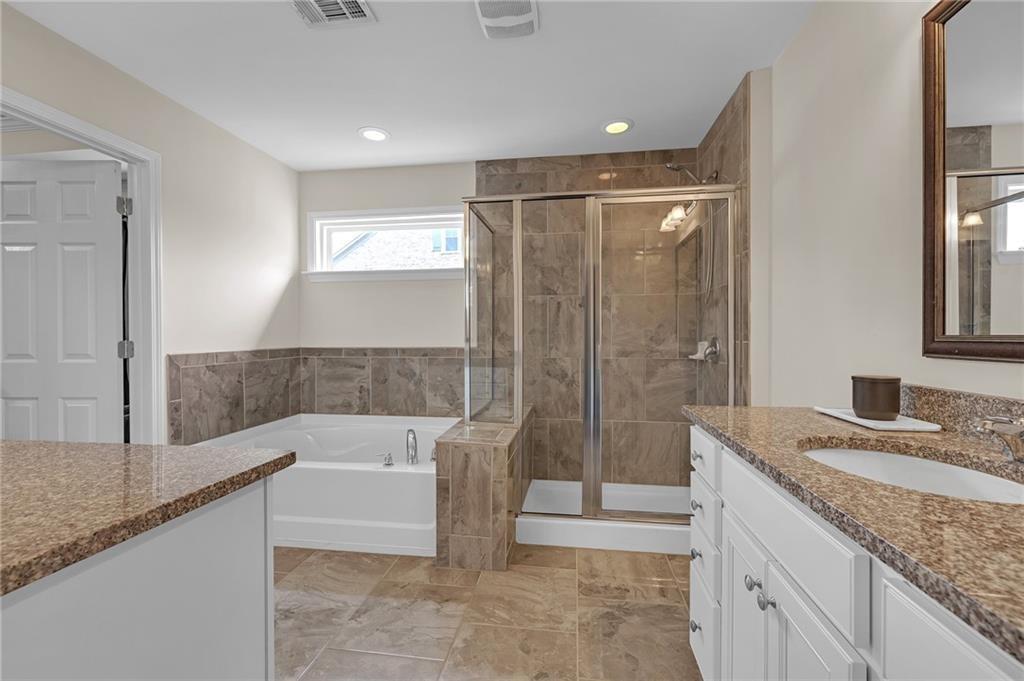 6513 Bennington Bluff Court, Unit 2 Mableton, GA 30126 - Photo 22 of 41 a bathroom with a granite countertop bathtub shower sink and mirror
