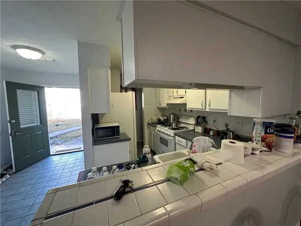 a kitchen with a stove a sink and a refrigerator