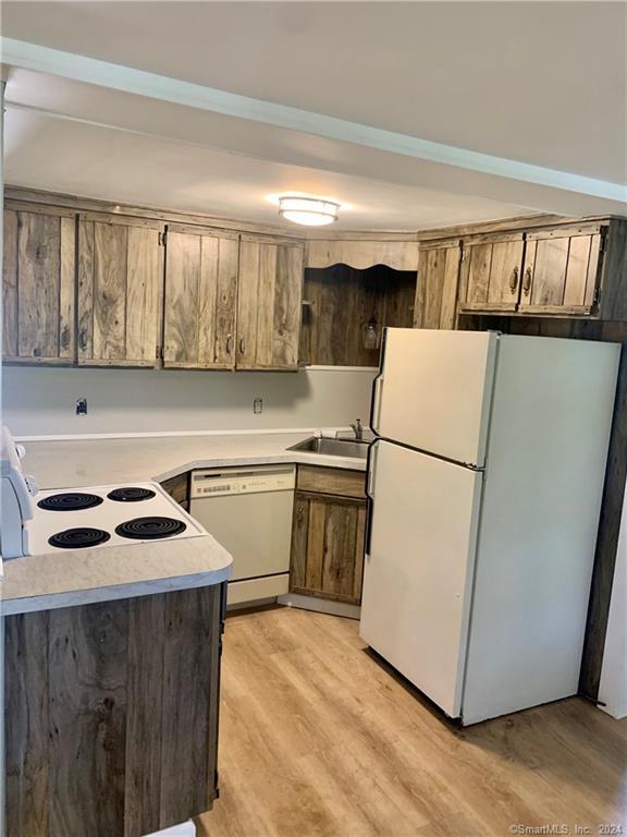 551 North Main Street, Unit 1R Naugatuck, CT 06770 - Photo 5 of 13 a kitchen with a stove a sink and a refrigerator
