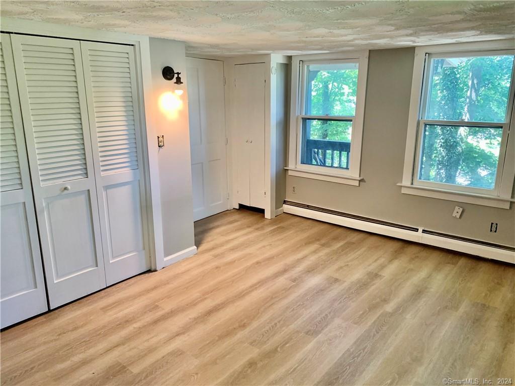 551 North Main Street, Unit 1R Naugatuck, CT 06770 - Photo 6 of 13 a view of an empty room with glass door and wooden floor