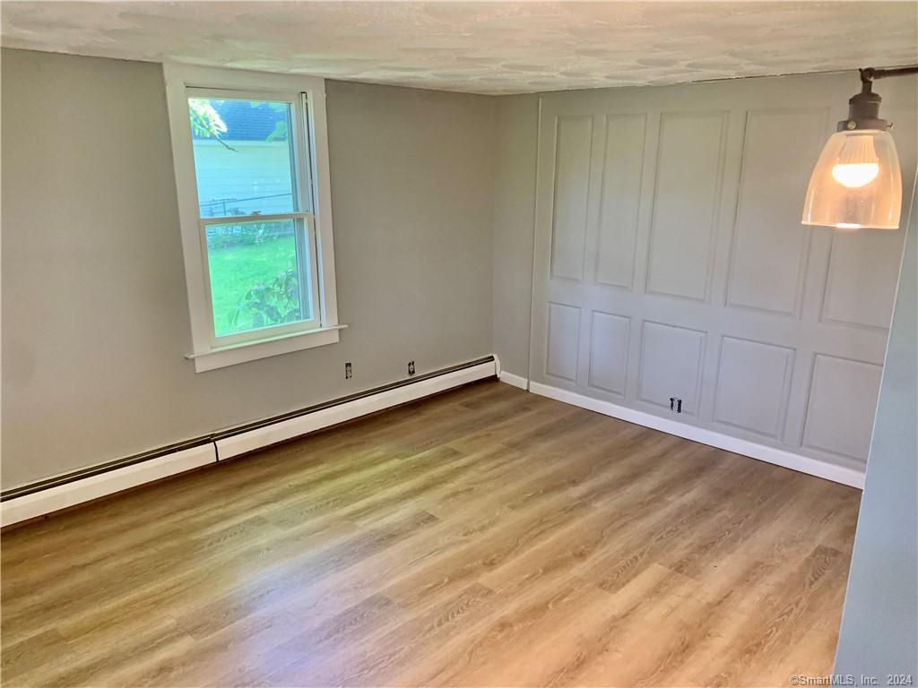 551 North Main Street, Unit 1R Naugatuck, CT 06770 - Photo 9 of 13 an empty room with wooden floor and windows