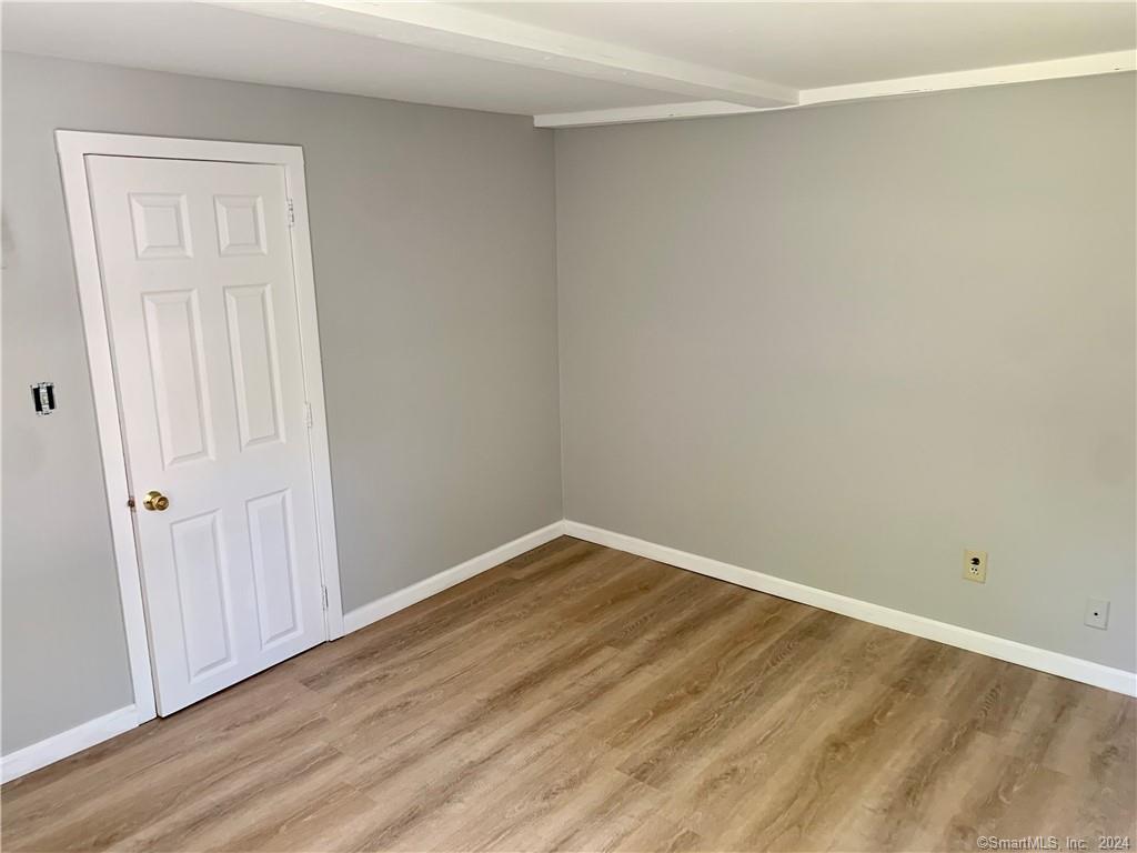 551 North Main Street, Unit 1R Naugatuck, CT 06770 - Photo 10 of 13 a view of an empty room with wooden floor