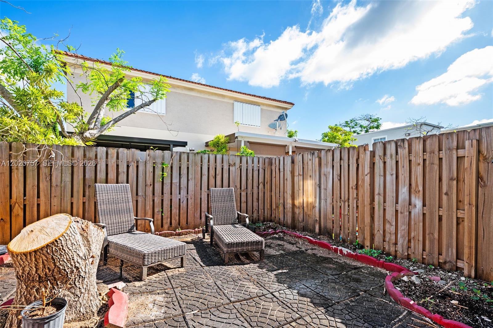 255 East 3rd Street, Unit 1 Hialeah, FL 33010 - Photo 22 of 38 a backyard of a house with table and chairs