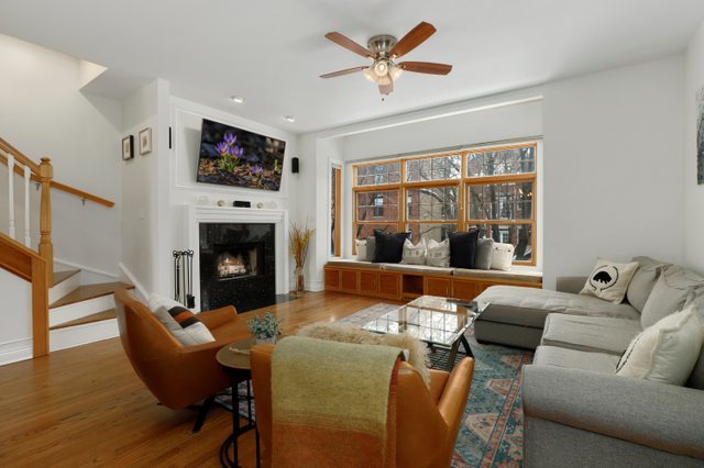 2651 West Rice Street Chicago, IL 60622 - Photo 2 of 20 a living room with furniture a flat screen tv and a fireplace