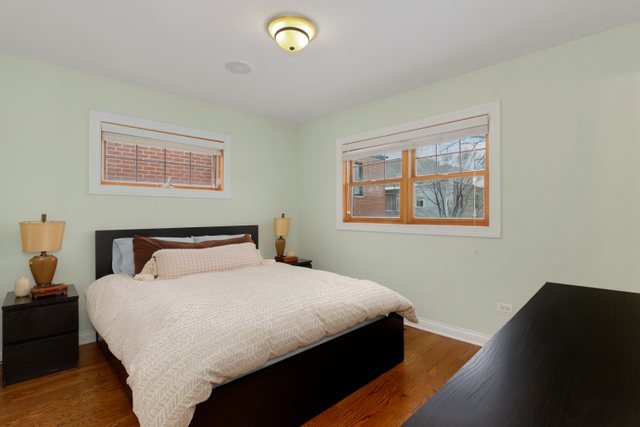 2651 West Rice Street Chicago, IL 60622 - Photo 15 of 20 a bedroom with a bed and wooden floor
