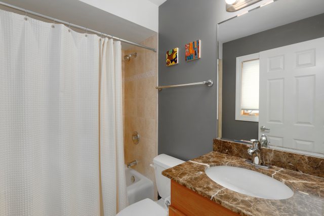 2651 West Rice Street Chicago, IL 60622 - Photo 16 of 20 a bathroom with a granite countertop sink and a mirror