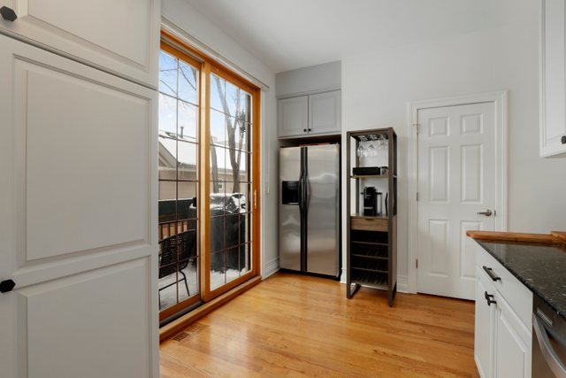 2651 West Rice Street Chicago, IL 60622 - Photo 9 of 20 a kitchen with stainless steel appliances granite countertop a refrigerator and a sink