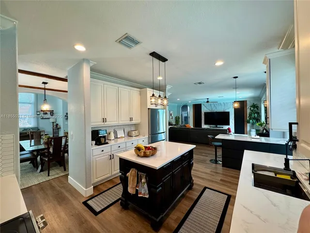 a kitchen with a sink stainless steel appliances and window