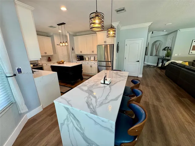 a kitchen with a stove a sink and a refrigerator