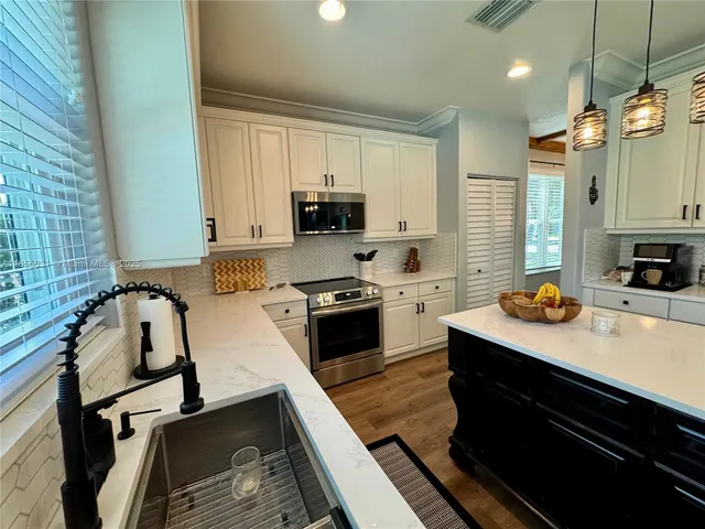 a living room with furniture fireplace and a large window