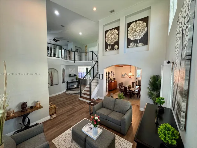 a living room with furniture and a wooden floor
