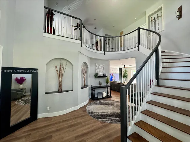 a bedroom with a bed wooden floor and window