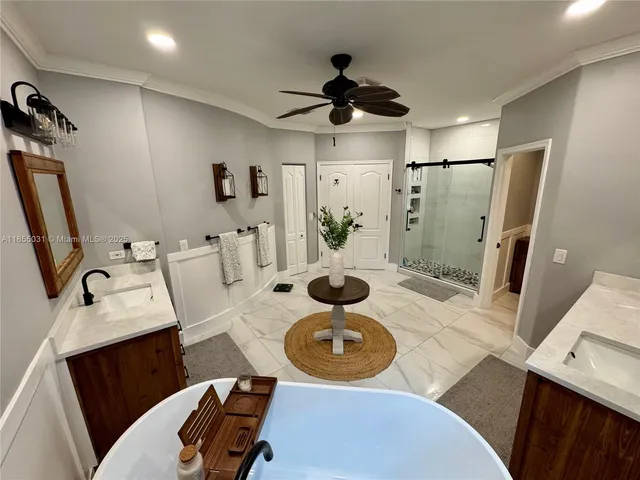 a bathroom with a sink toilet mirror vanity and shower