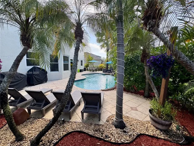 a view of a backyard with swimming pool