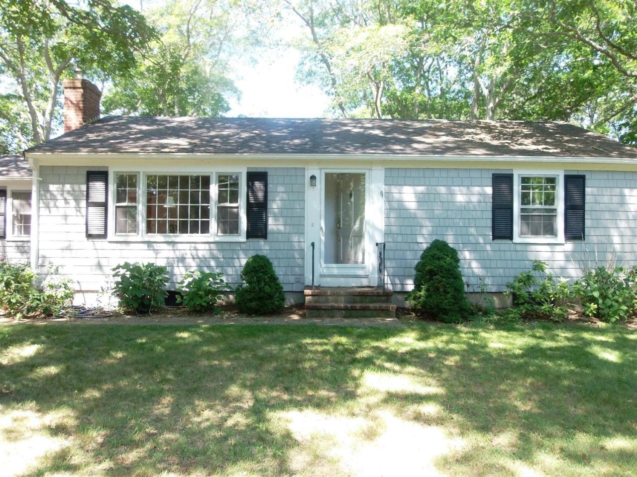 a view of a house with a garden and plants