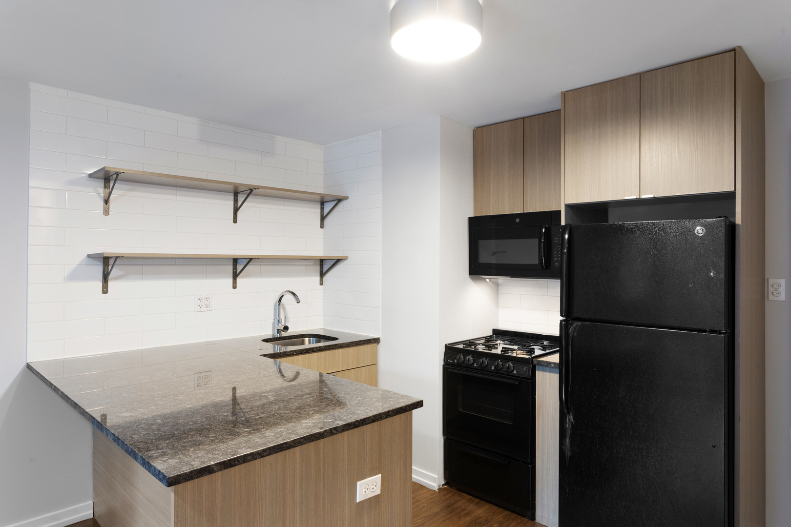5411 North Winthrop Avenue, Unit 513 Chicago, IL 60640 - Photo 4 of 14 a kitchen with a refrigerator and a sink