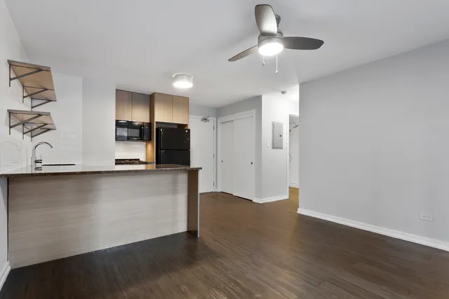a view of kitchen with cabinets and wooden floor