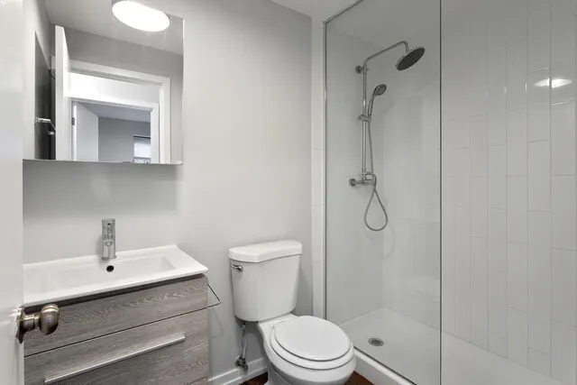 a bathroom with a toilet a sink and shower