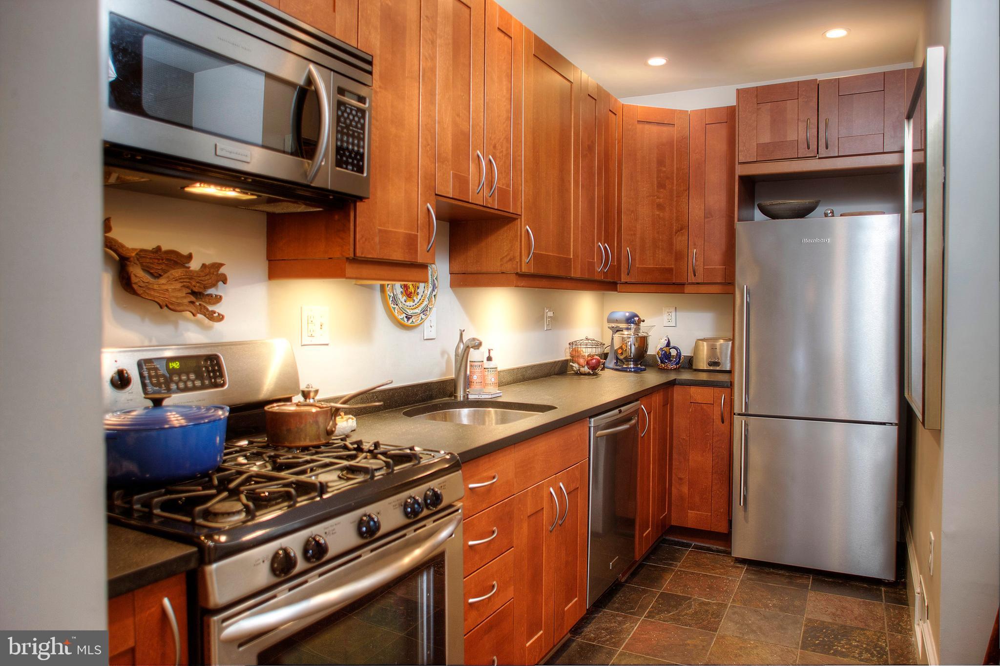 1615 East Moyamensing Avenue Philadelphia, PA 19148 - Photo 10 of 17 a kitchen with a stove and a refrigerator