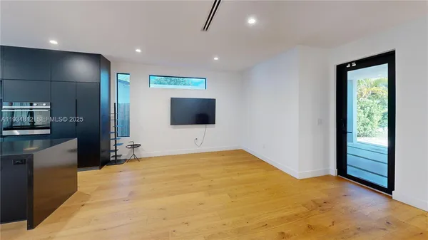 a view of an empty room with a flat screen tv
