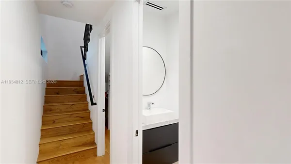 a view of a hallway with wooden floor