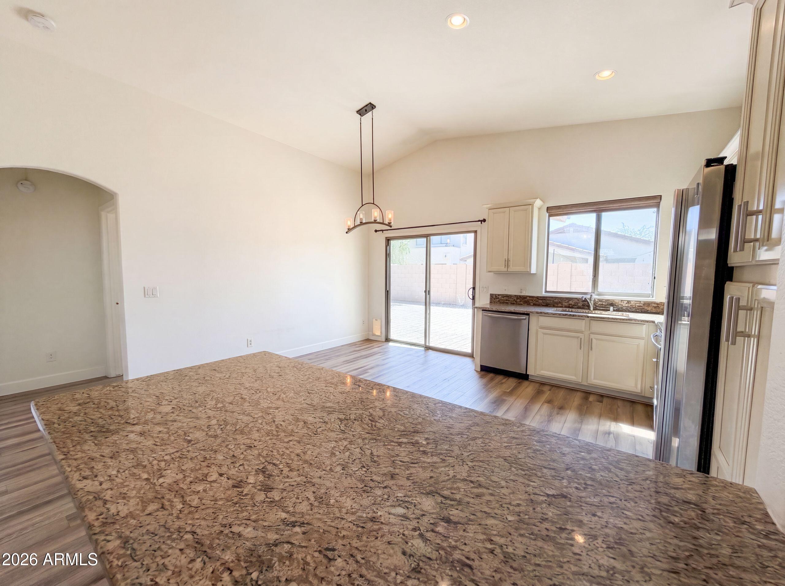 3951 East Timberline Road Gilbert, AZ 85297 - Photo 8 of 28 a view of a kitchen with refrigerator and window