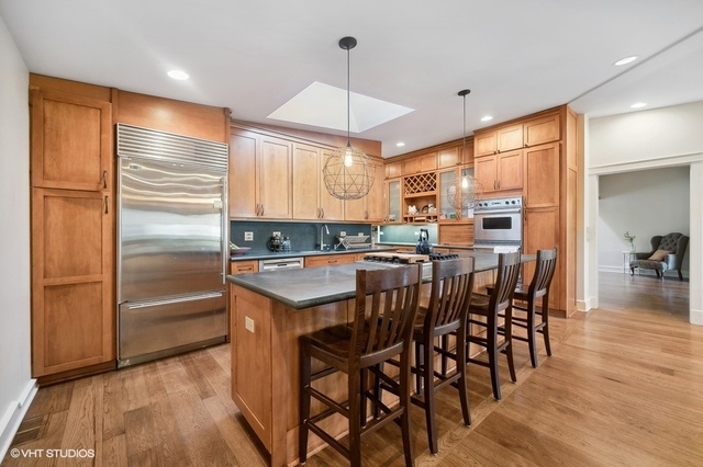 687 Birch Road Glencoe, IL 60022 - Photo 16 of 38 a kitchen with granite countertop a refrigerator a stove a sink and a dining table with wooden floor