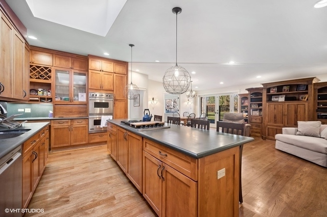 687 Birch Road Glencoe, IL 60022 - Photo 17 of 38 a kitchen with stainless steel appliances granite countertop a sink a stove and a wooden floors