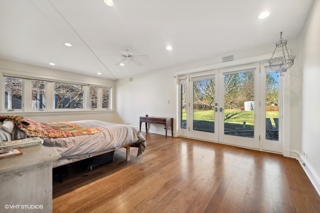 687 Birch Road Glencoe, IL 60022 - Photo 20 of 38 a bed sitting in a spacious bedroom next to a large window