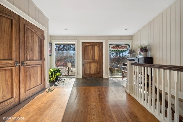 687 Birch Road Glencoe, IL 60022 - Photo 2 of 38 a view of a porch with wooden floor and windows