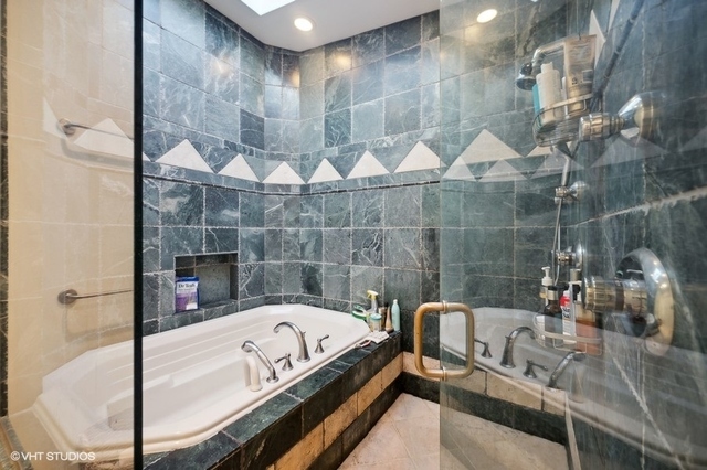 687 Birch Road Glencoe, IL 60022 - Photo 22 of 38 a bath tub sitting next to a bathroom sink