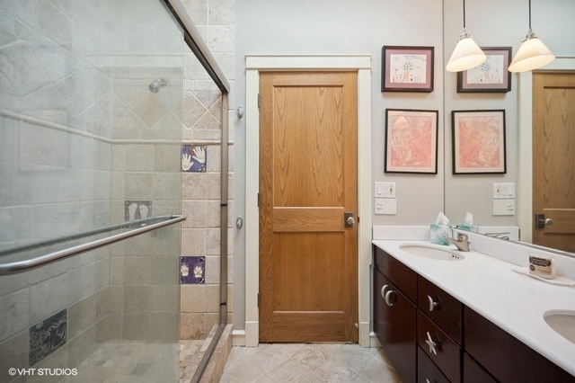 687 Birch Road Glencoe, IL 60022 - Photo 25 of 38 a bathroom with a double vanity sink a mirror and shower