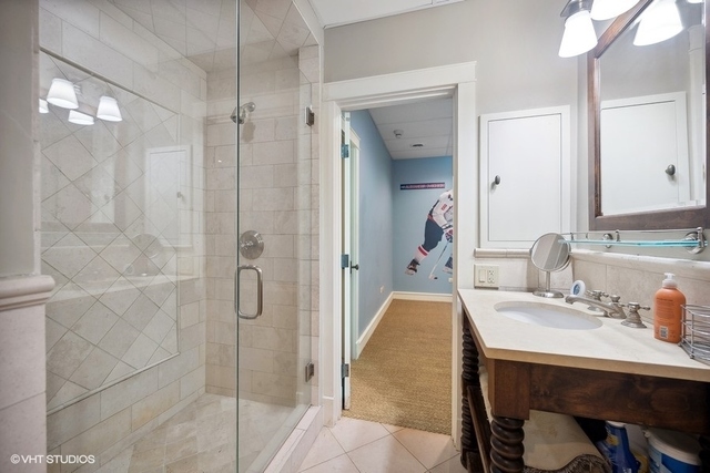 687 Birch Road Glencoe, IL 60022 - Photo 31 of 38 a en suite bathroom with a granite countertop sink and a mirror