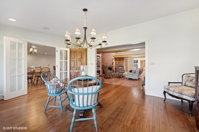 687 Birch Road Glencoe, IL 60022 - Photo 8 of 38 a dining room with furniture a chandelier and wooden floor